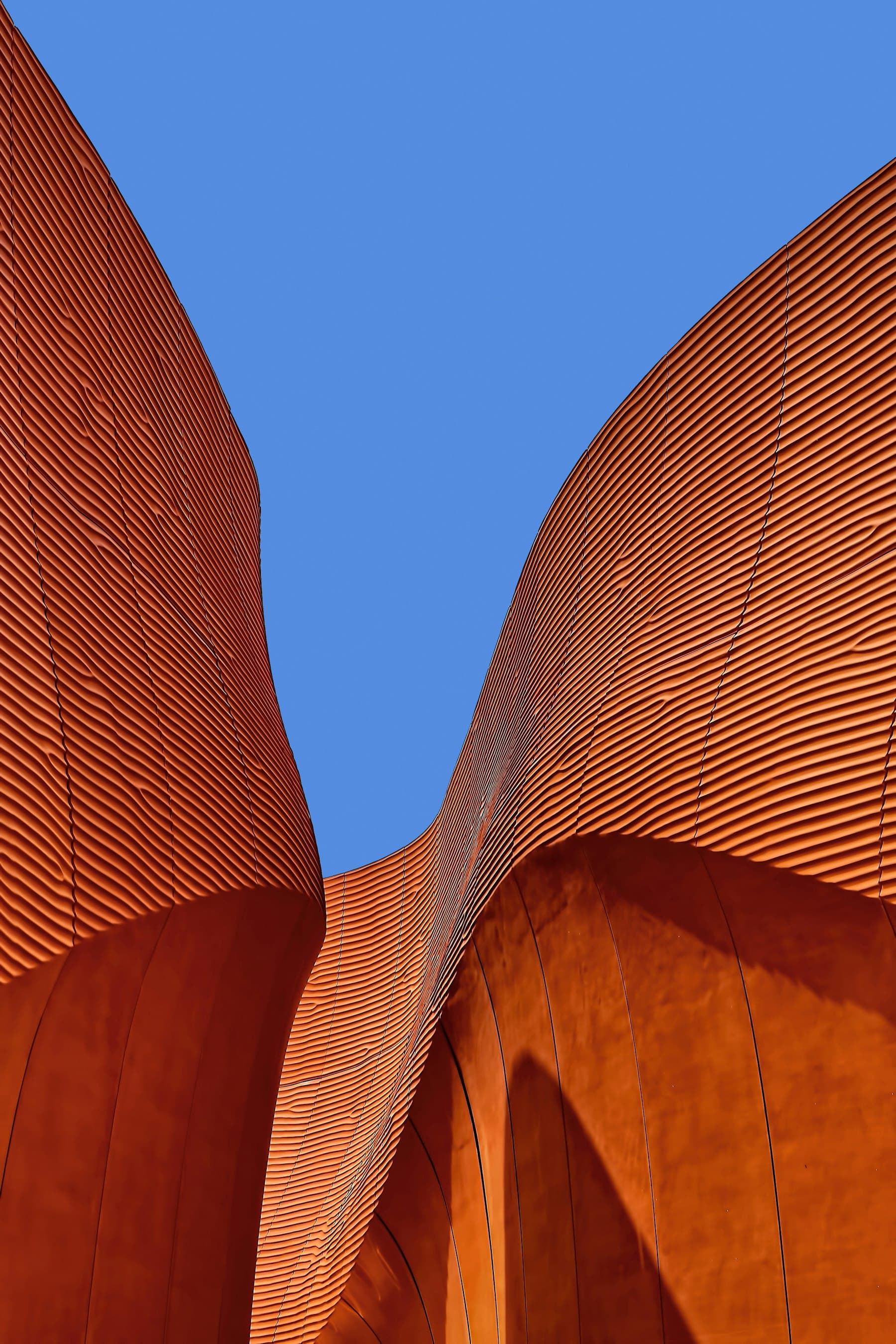 Abstract modern architecture with sweeping orange curves